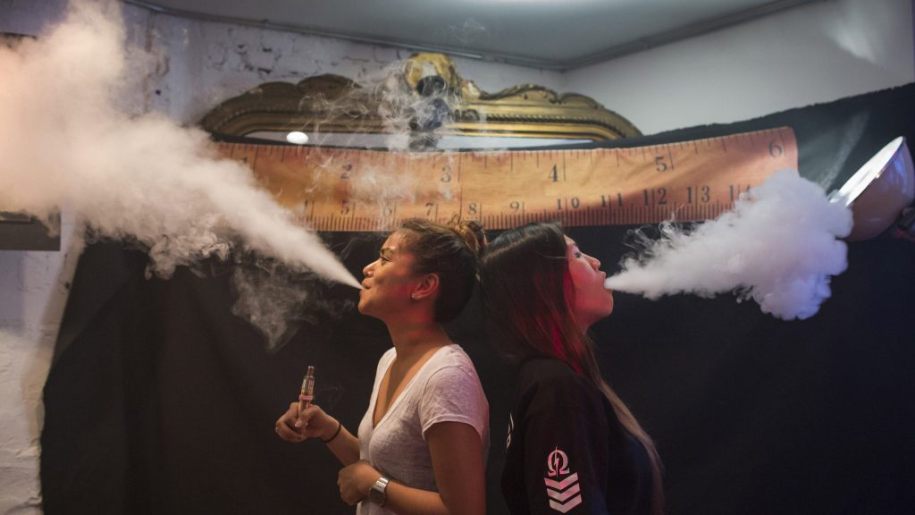 Vape was chosen as the word of the year for 2014 in part because it provides a window "onto how we define ourselves," says Casper Grathwohl of the Oxford University Press. Here, women exhale vapor clouds during a competition at the Henley Vaporium in Manhattan.